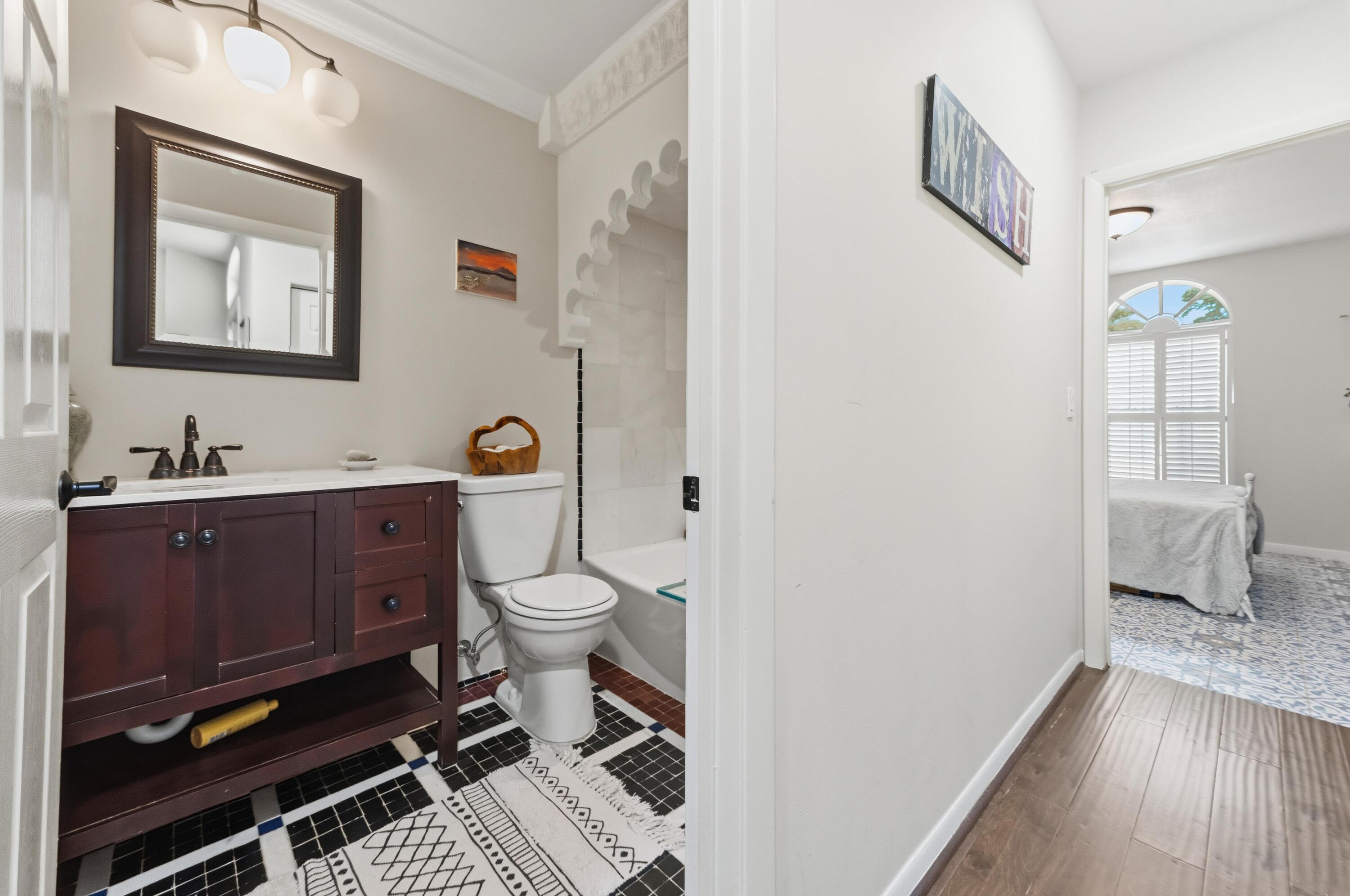 17221 Boca Club Boulevard, Unit 3 Boca Raton, FL 33487 - Photo 23 of 47 a bathroom with a toilet a sink and a window