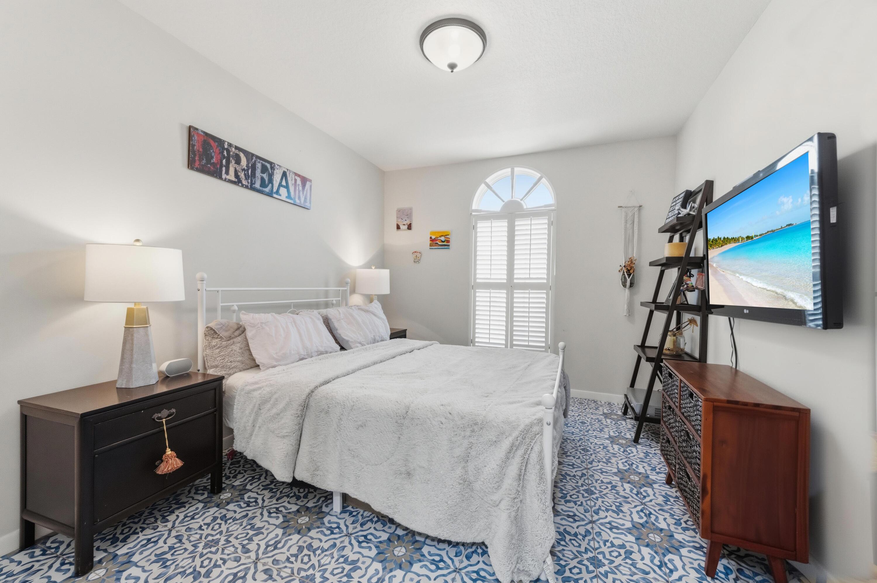 17221 Boca Club Boulevard, Unit 3 Boca Raton, FL 33487 - Photo 25 of 47 a bedroom with a bed and a flat tv screen on dresser