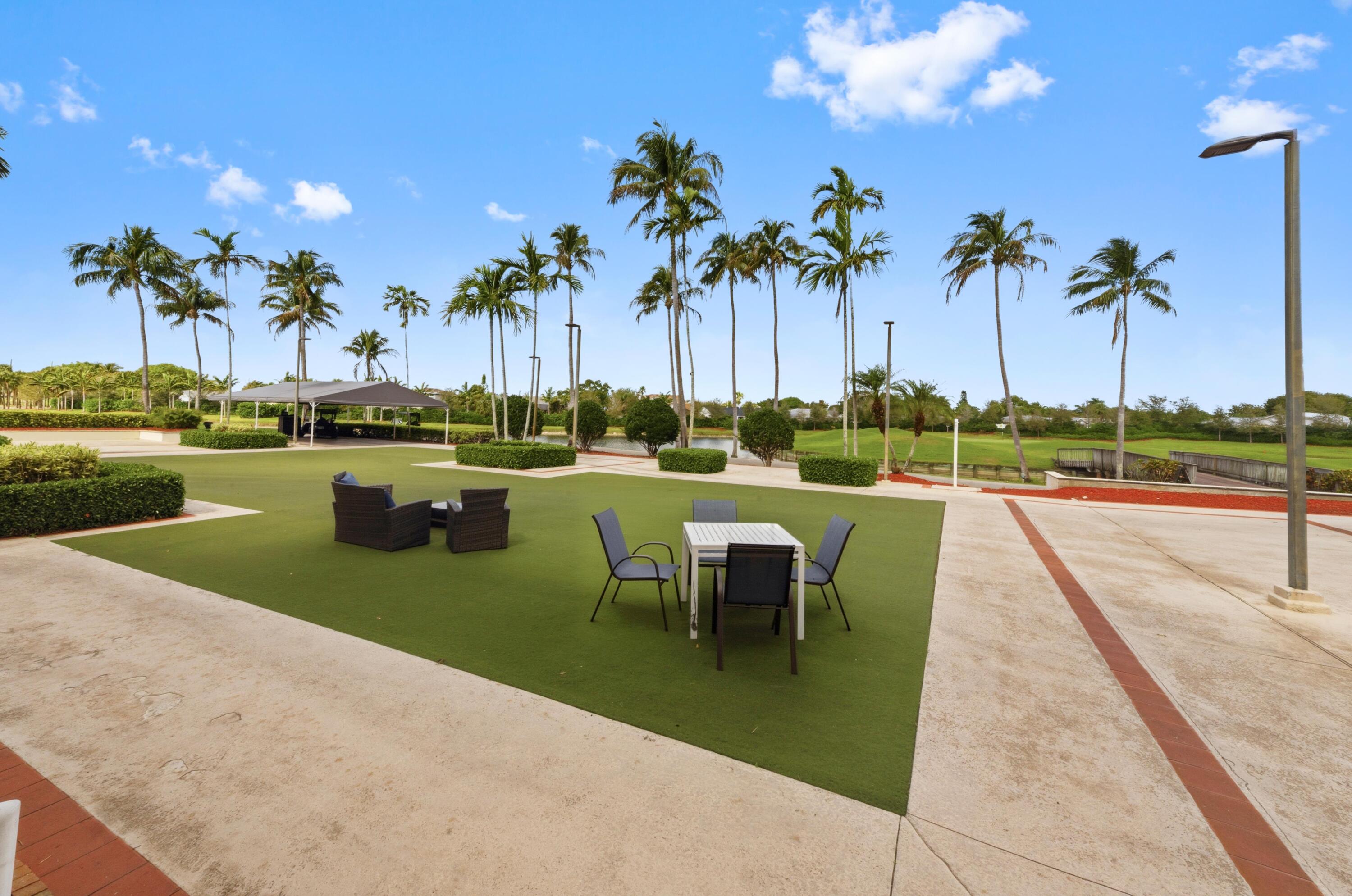 17221 Boca Club Boulevard, Unit 3 Boca Raton, FL 33487 - Photo 38 of 47 a view of a lake with a table and chairs