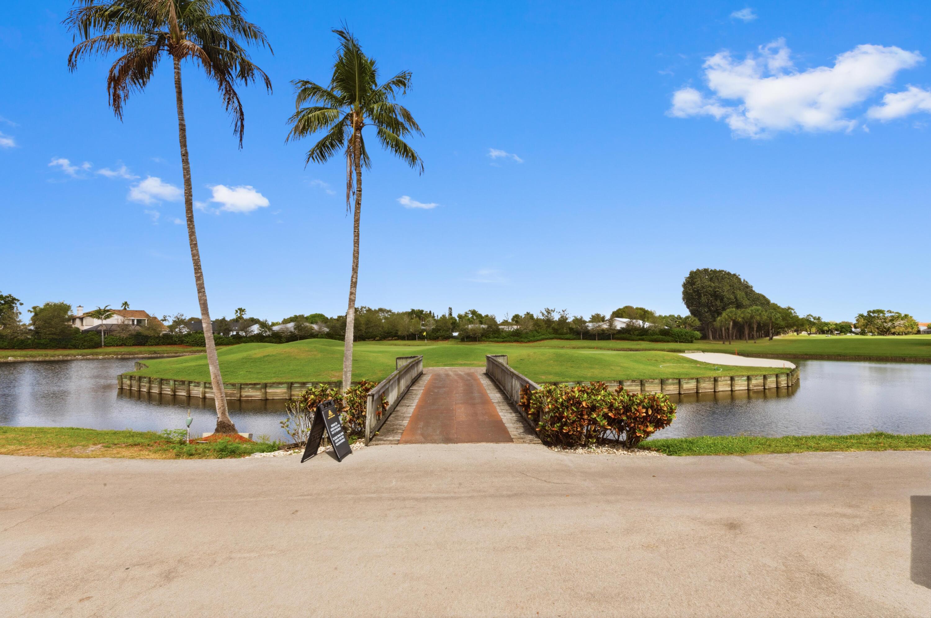 17221 Boca Club Boulevard, Unit 3 Boca Raton, FL 33487 - Photo 39 of 47 a view of a lake with a palm tree next to a yard