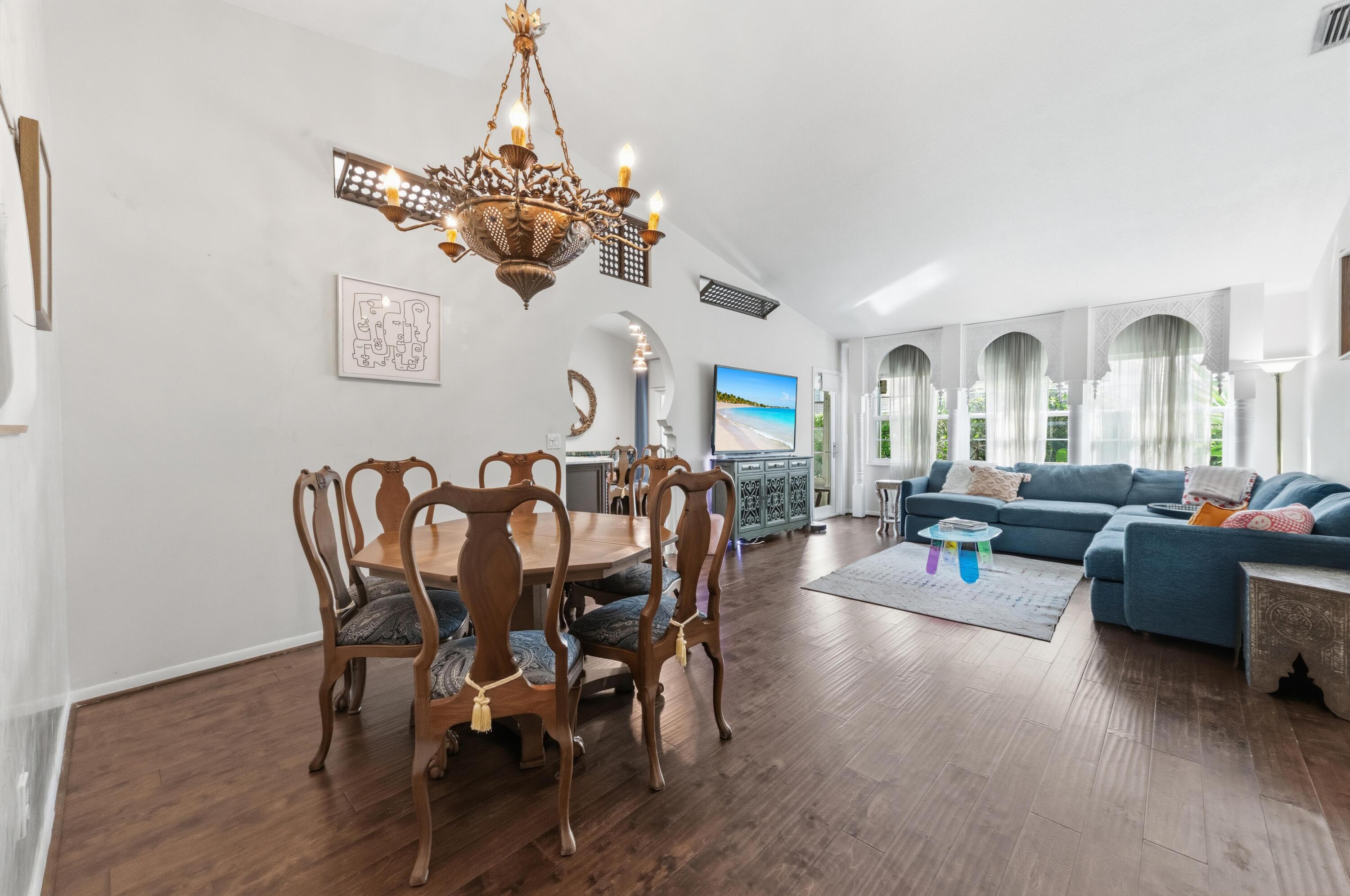 17221 Boca Club Boulevard, Unit 3 Boca Raton, FL 33487 - Photo 5 of 47 a view of a dining room with furniture wooden floor and chandelier