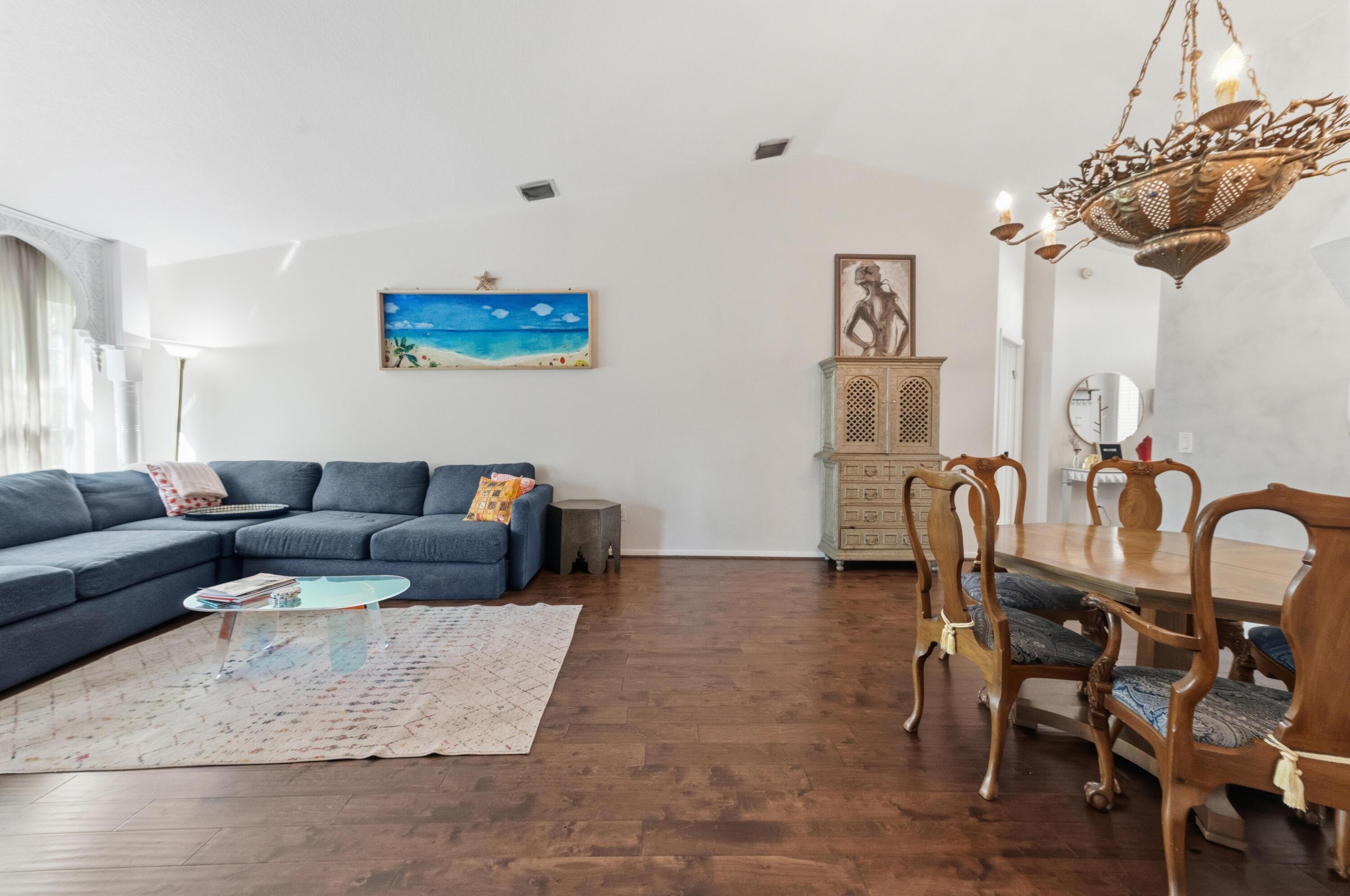 17221 Boca Club Boulevard, Unit 3 Boca Raton, FL 33487 - Photo 6 of 47 a living room with furniture and a chandelier