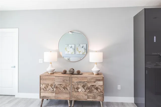 a room with furniture a mirror and lamp