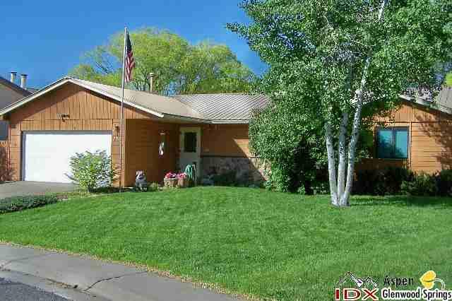 752 Cactus Court Rifle, CO 81650 - Photo 1 of 7 a front view of a house with a yard