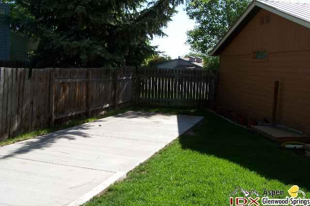 752 Cactus Court Rifle, CO 81650 - Photo 7 of 7 a view of backyard with wooden fence and trees