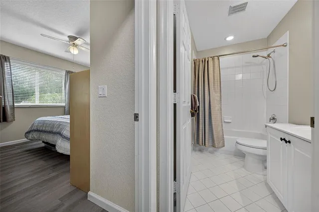 a bathroom with a toilet shower and a bath tub