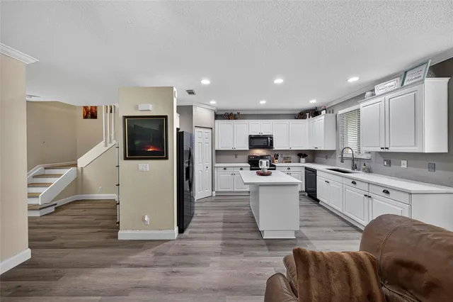 a kitchen with a sink stainless steel appliances and cabinets