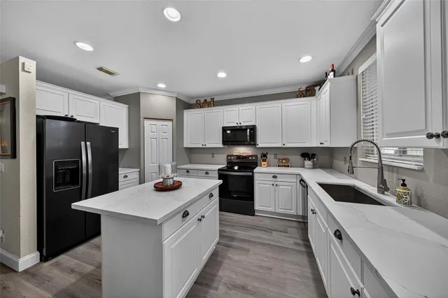 a kitchen with a sink stove and refrigerator