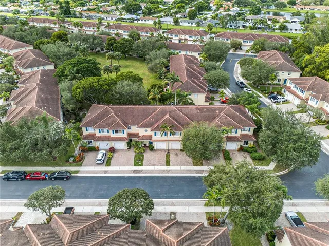 an aerial view of residential houses with outdoor space and street view
