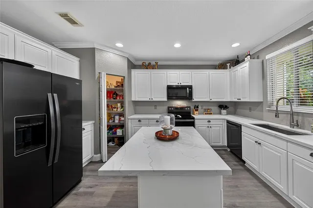 a kitchen with stainless steel appliances a refrigerator sink and microwave