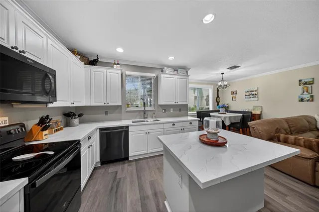 a kitchen with a sink a stove and cabinets