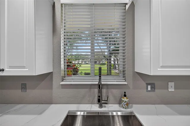 a bathroom with a sink and a window