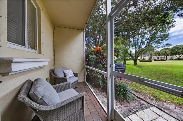 a view of balcony with couch and trees