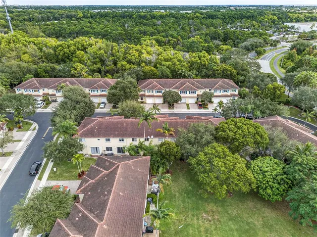 an aerial view of residential houses with outdoor space and street view