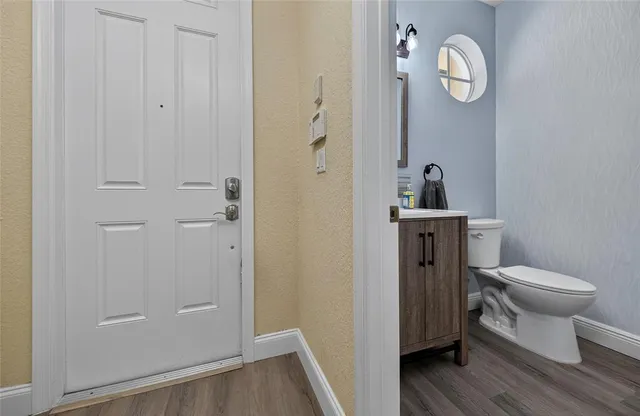 a view of grassy field with benches and trees all around