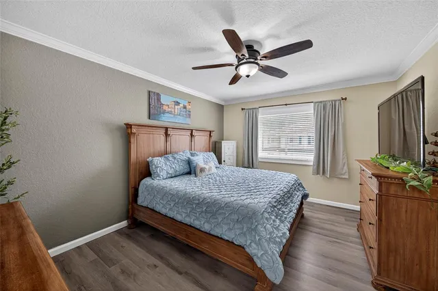 a bedroom with a large bed and a window