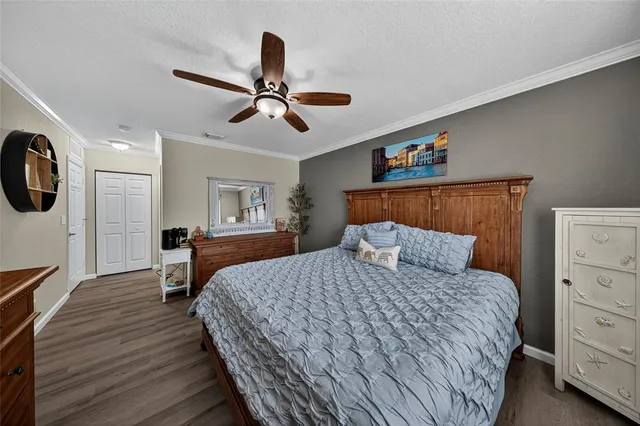a bedroom with a large bed and a chandelier