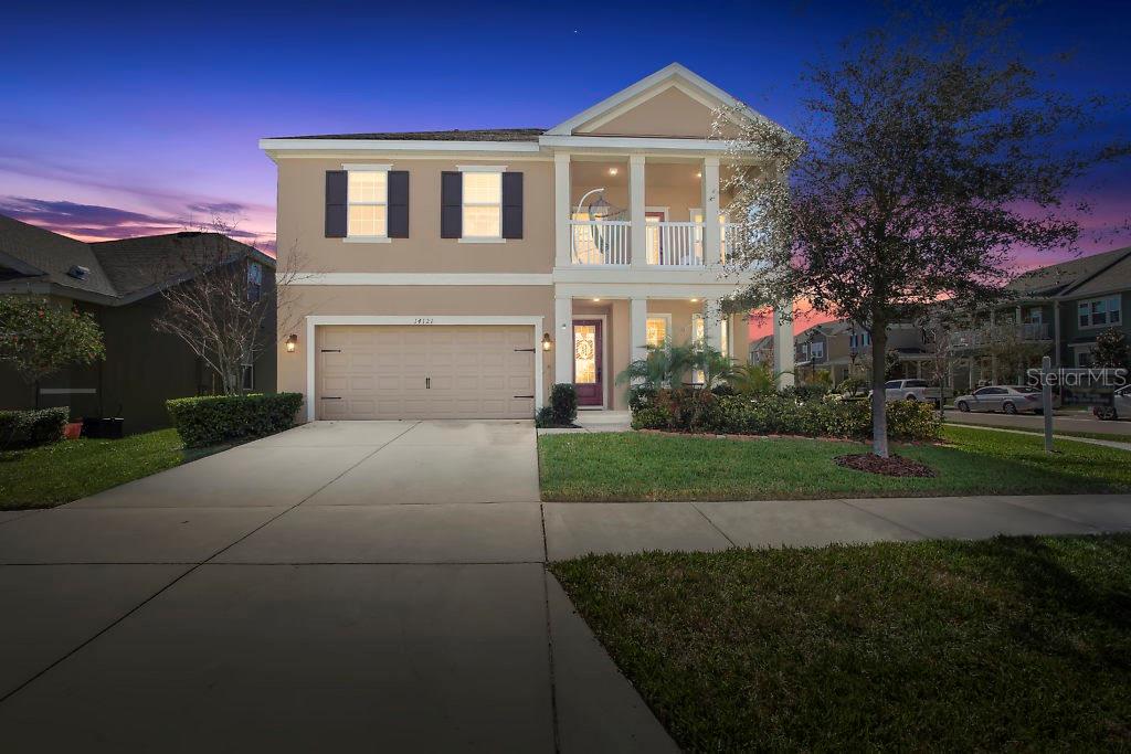 14121 Quarry Lake Road Lithia, FL 33547 - Photo 1 of 1 a front view of a house with a yard and garage