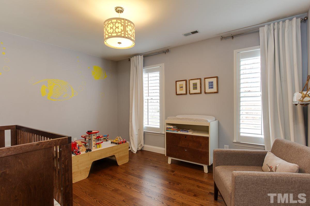 7904 Ogden Court Raleigh, NC 27613 - Photo 22 of 25 a livingroom with toys and a chandelier
