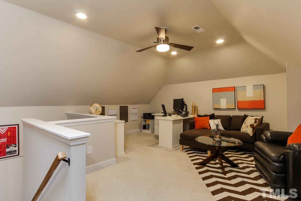 7904 Ogden Court Raleigh, NC 27613 - Photo 23 of 25 a living room with furniture and a flat screen tv
