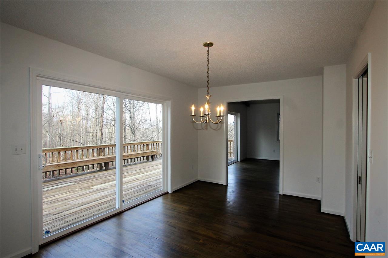 896 Dry Bridge Road Charlottesville, VA 22903 - Photo 13 of 47 a view of a livingroom with wooden floor staircase and a kitchen space