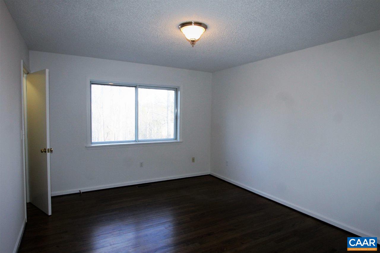 896 Dry Bridge Road Charlottesville, VA 22903 - Photo 21 of 47 a view of an empty room with wooden floor and a window