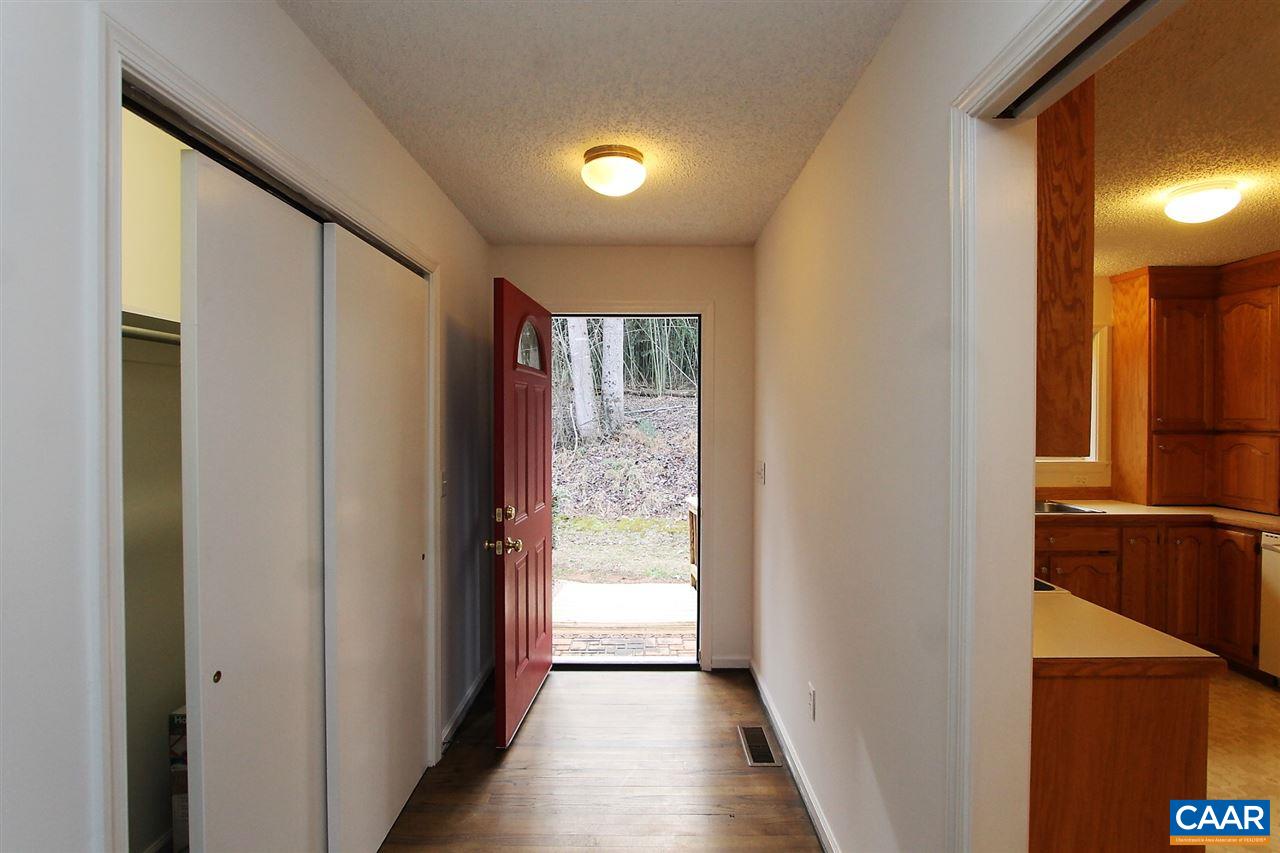 896 Dry Bridge Road Charlottesville, VA 22903 - Photo 7 of 47 a view of a hallway with wooden floor and a bathroom