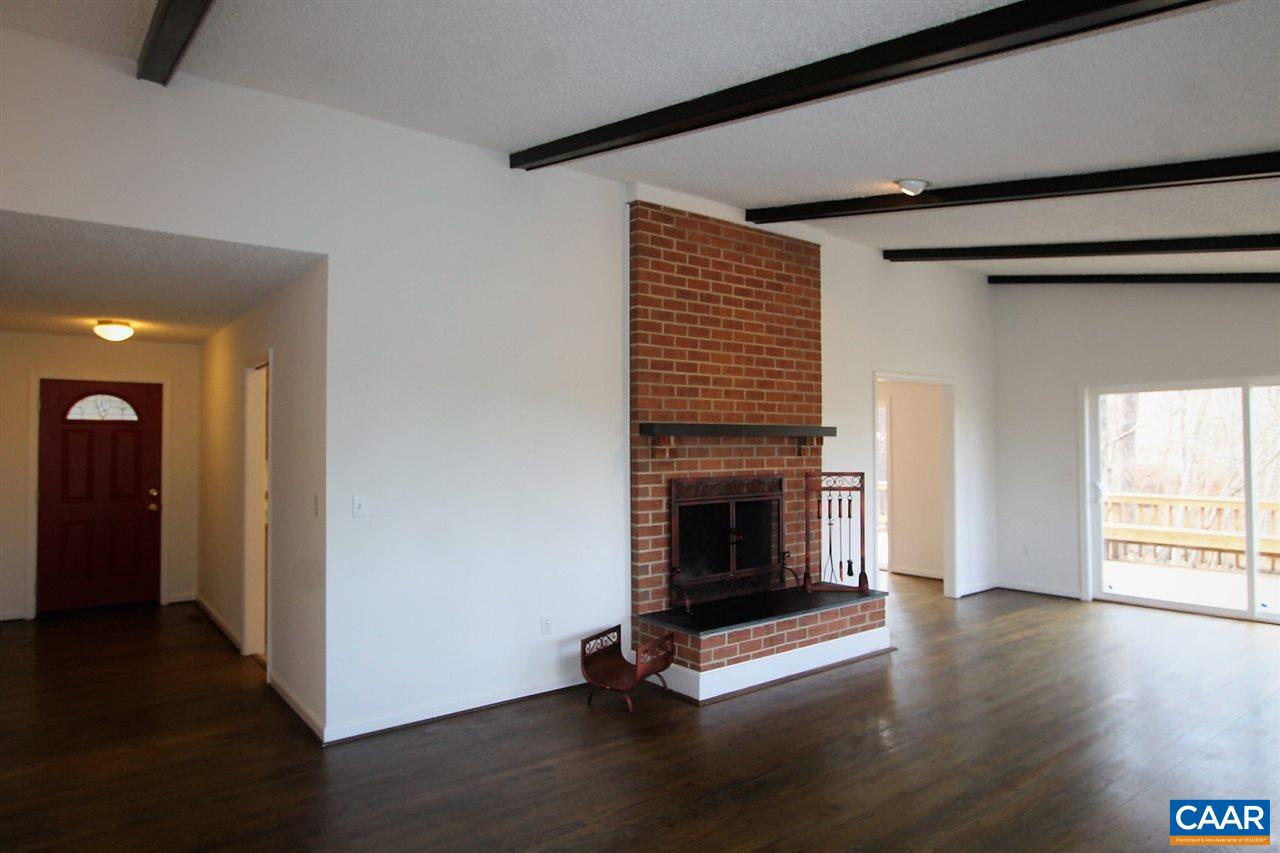 896 Dry Bridge Road Charlottesville, VA 22903 - Photo 9 of 47 a view of a livingroom with wooden floor and a fireplace