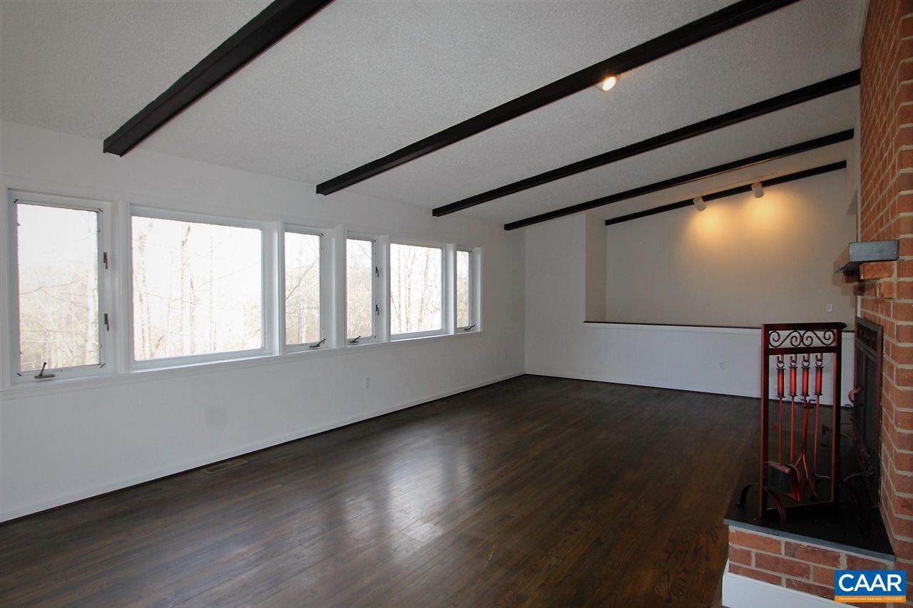 896 Dry Bridge Road Charlottesville, VA 22903 - Photo 10 of 47 a view of an empty room with wooden floor and a window