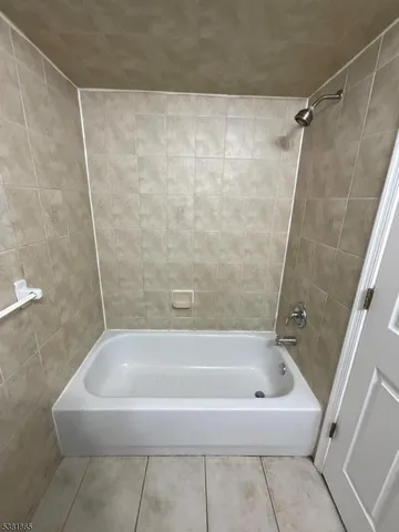 a white bath tub and a shower