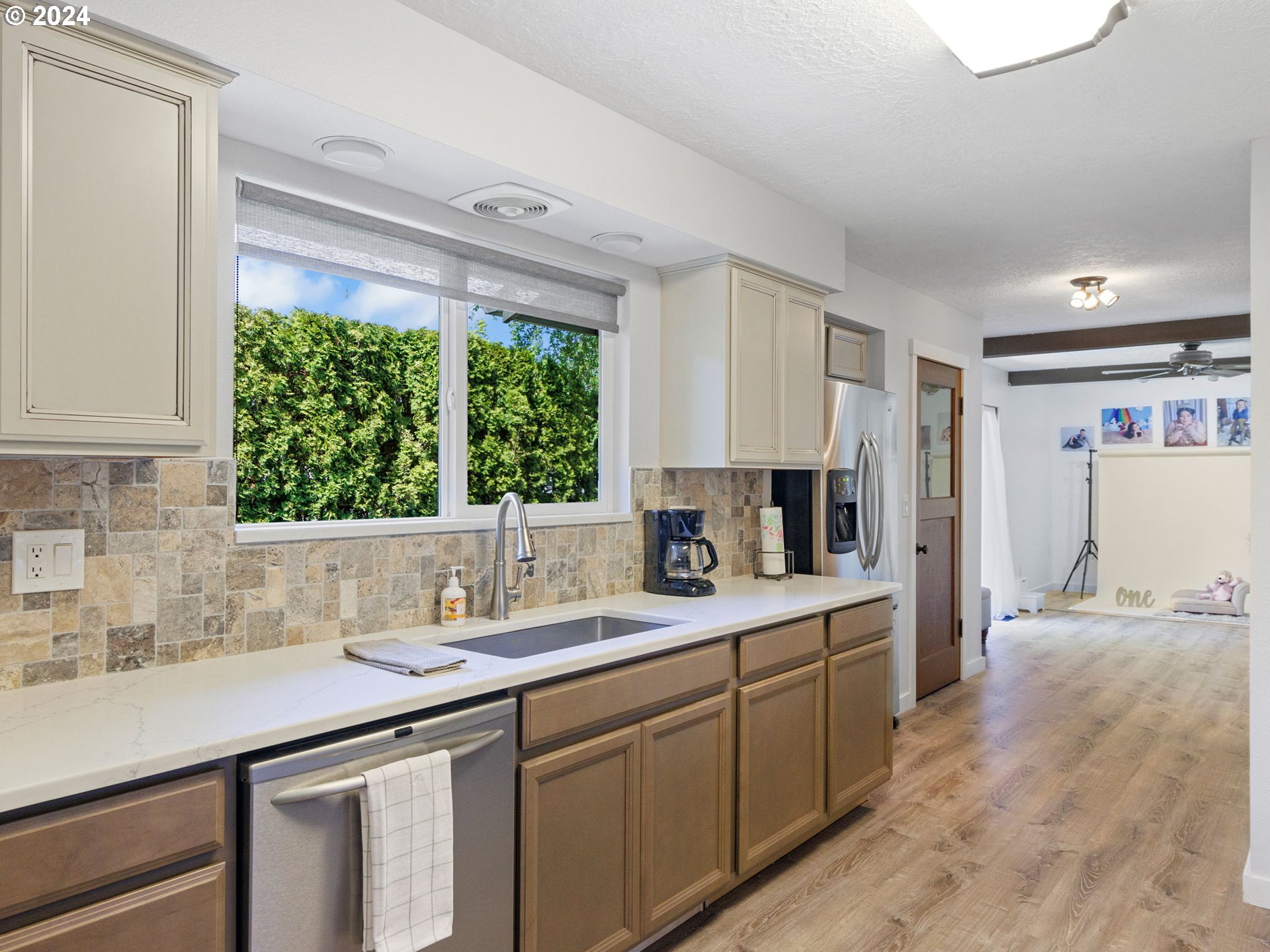 2551 Southeast Barnes Road Gresham, OR 97080 - Photo 12 of 38 a kitchen with a sink window and cabinets