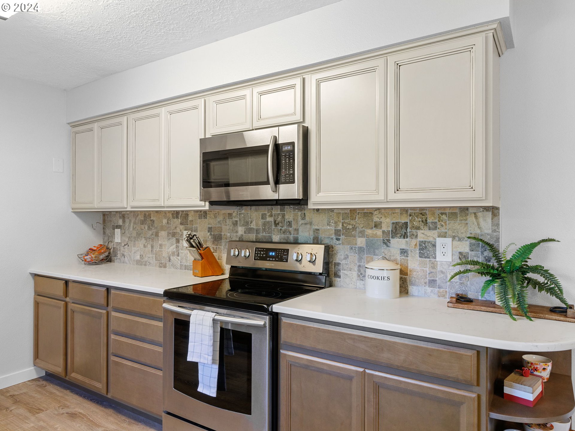 2551 Southeast Barnes Road Gresham, OR 97080 - Photo 13 of 38 a kitchen with stainless steel appliances white cabinets and a stove top oven