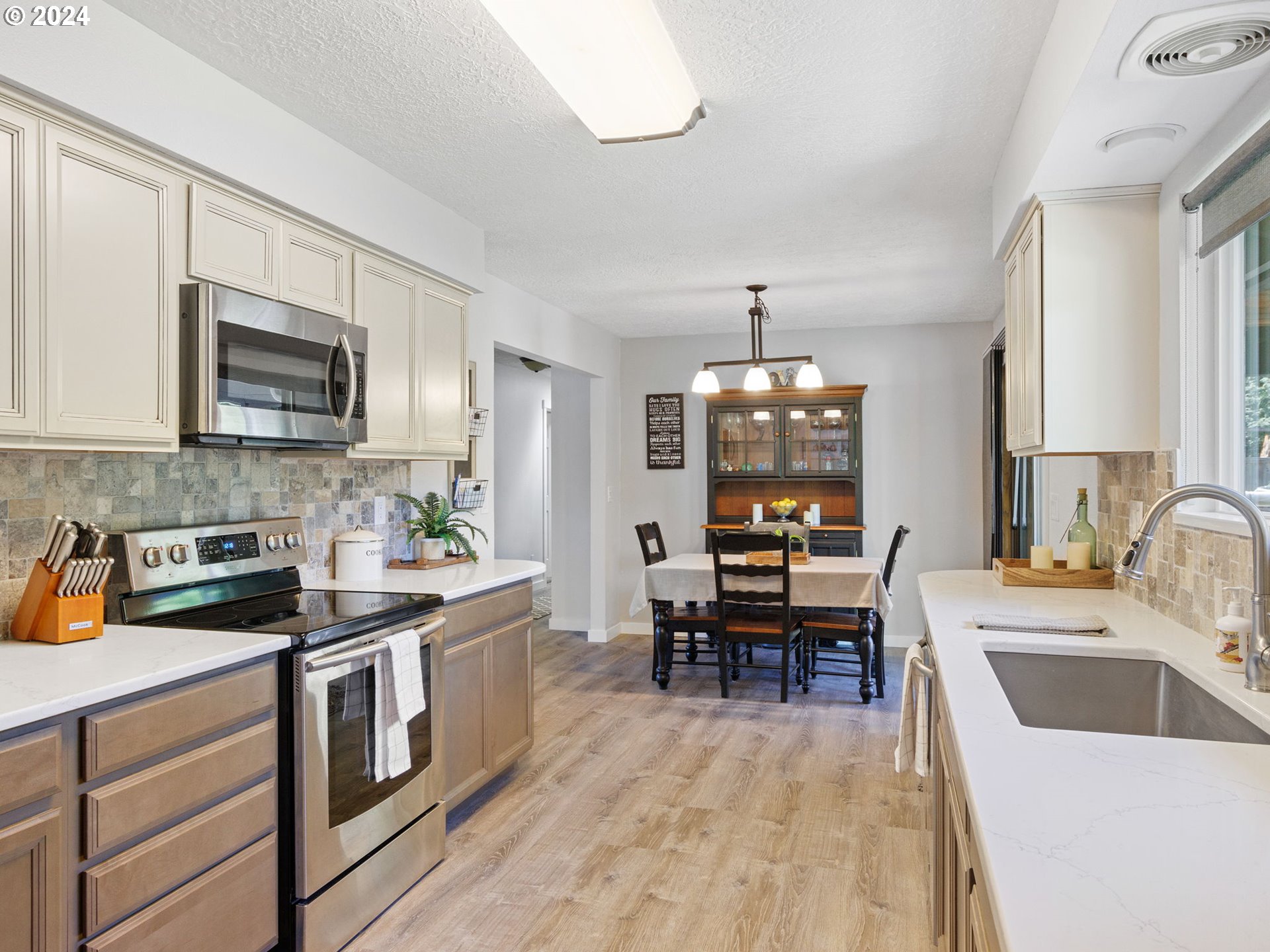 2551 Southeast Barnes Road Gresham, OR 97080 - Photo 14 of 38 a kitchen with a sink stove and microwave