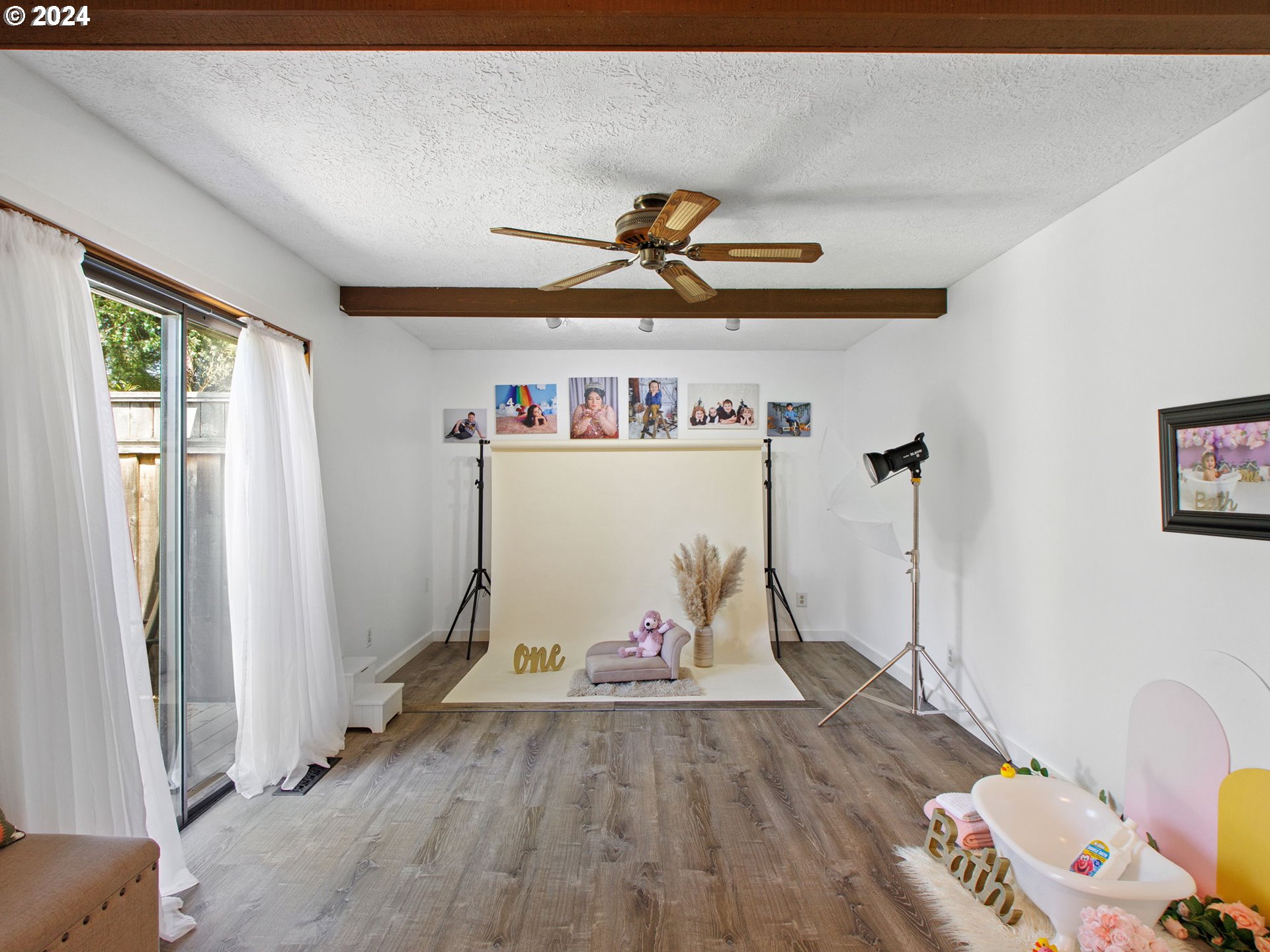 2551 Southeast Barnes Road Gresham, OR 97080 - Photo 15 of 38 a view of a livingroom with wooden floor and a flat screen tv