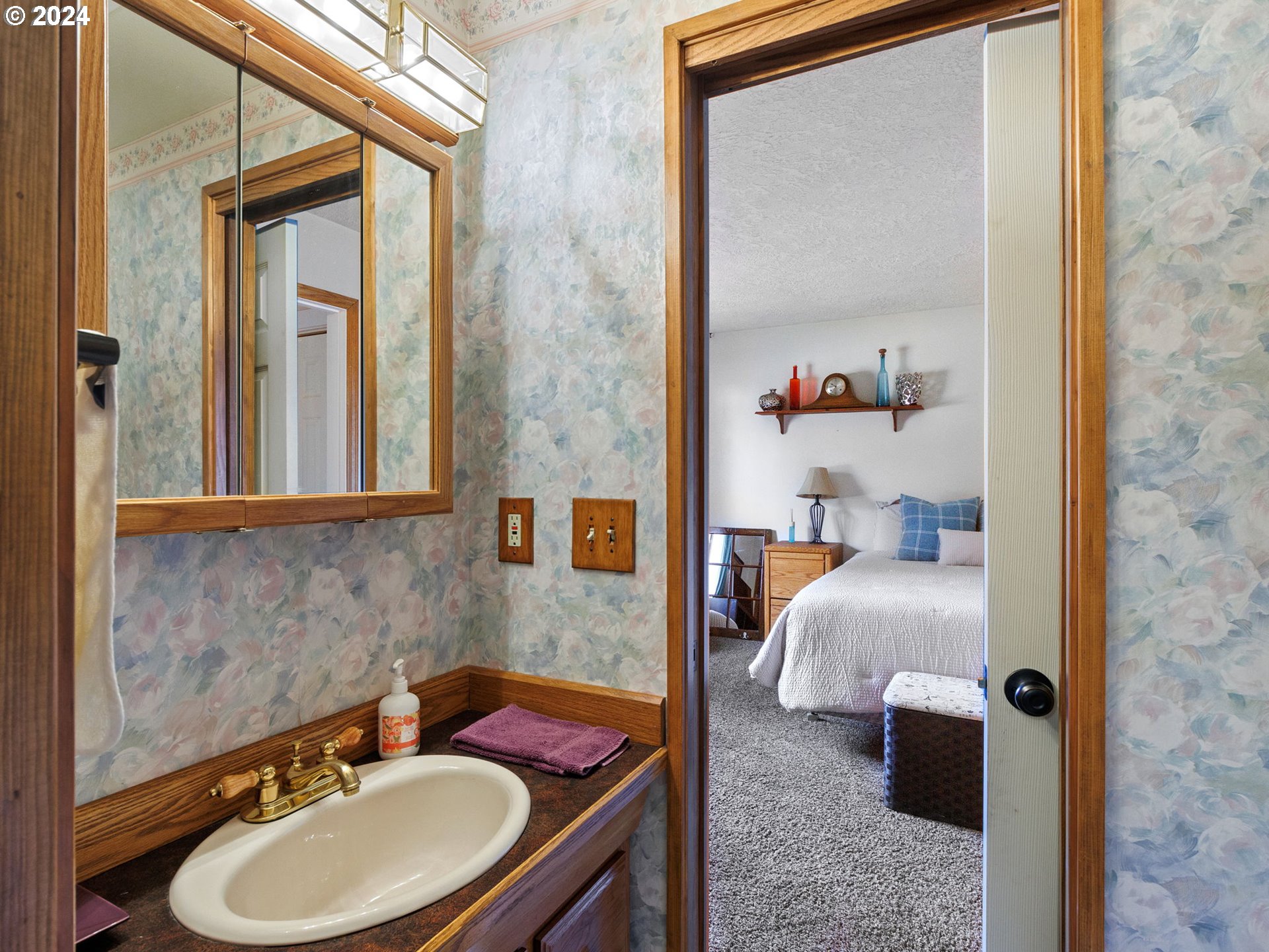 2551 Southeast Barnes Road Gresham, OR 97080 - Photo 23 of 38 a bathroom with a sink and a mirror
