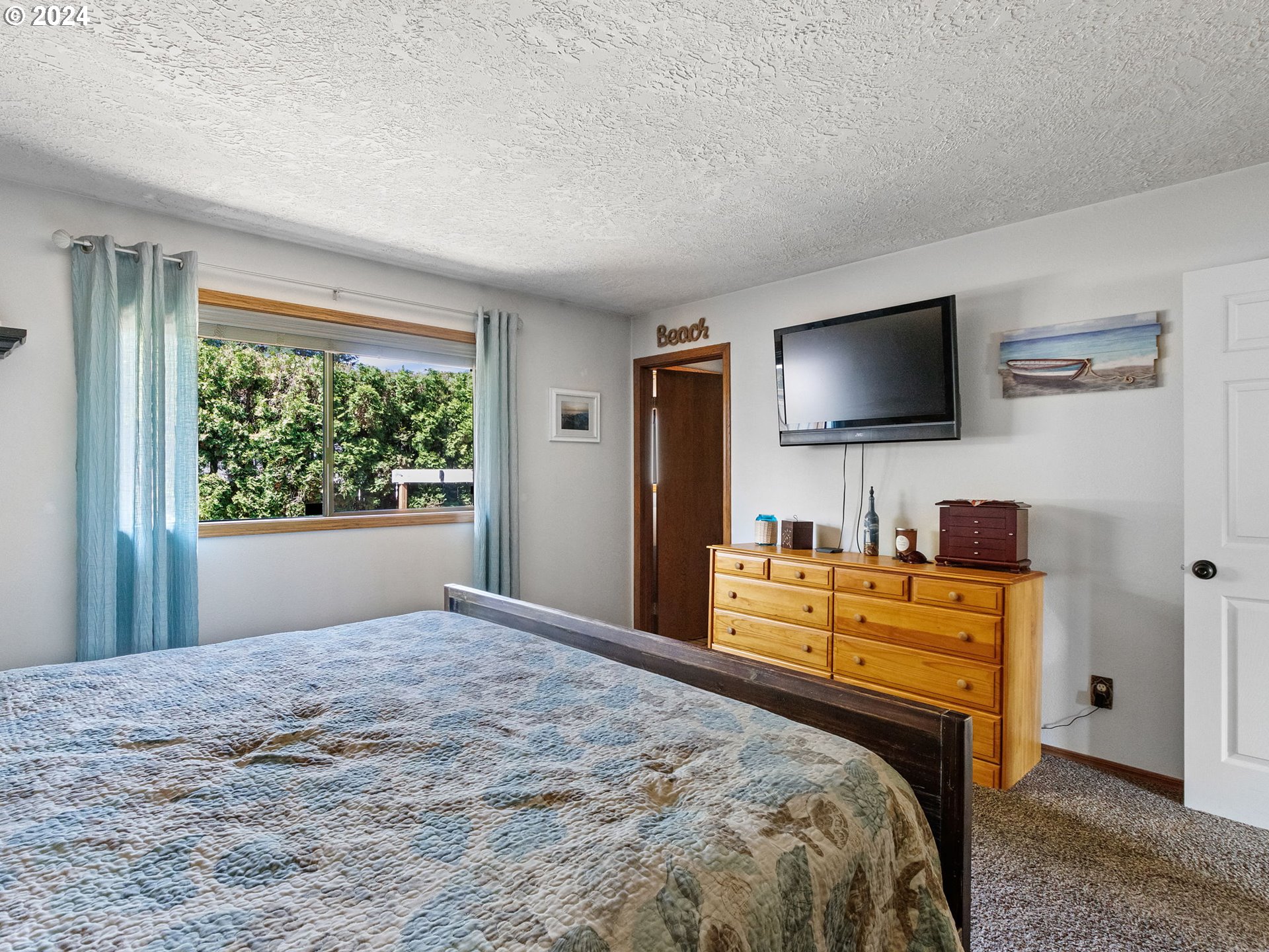2551 Southeast Barnes Road Gresham, OR 97080 - Photo 27 of 38 a bedroom with a bed and a flat screen tv