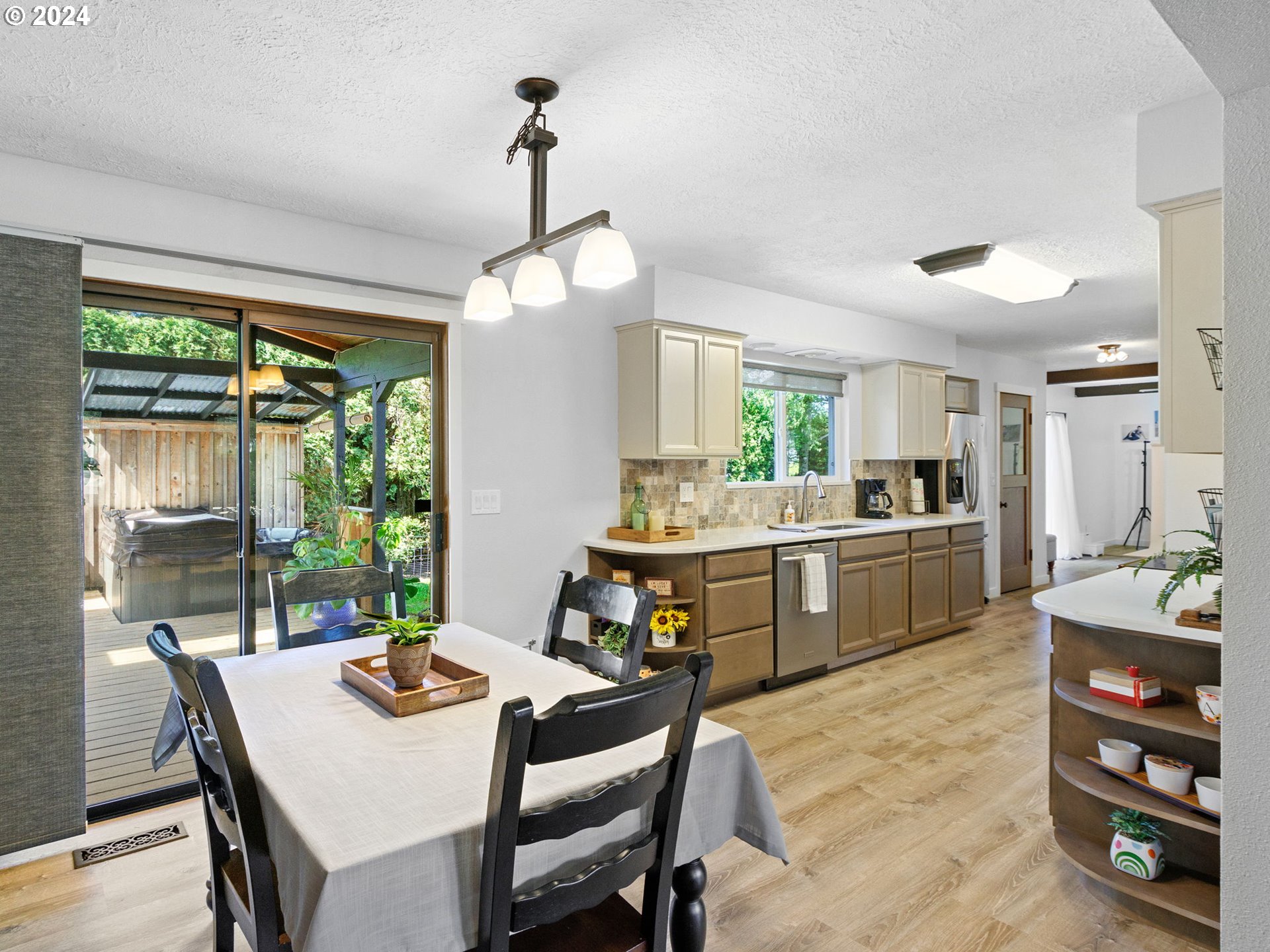 2551 Southeast Barnes Road Gresham, OR 97080 - Photo 9 of 38 a kitchen with a table chairs stove and refrigerator