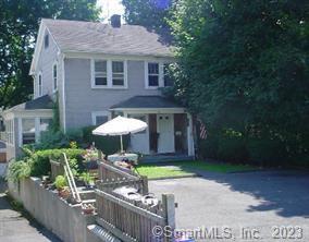 a front view of a house with garden and porch