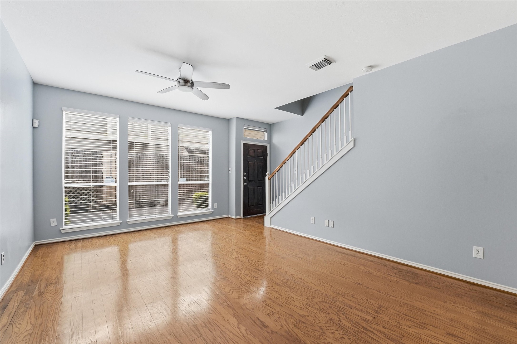 1507 Sutton Street Houston, TX 77006 - Photo 6 of 31 a view of an empty room with a window and wooden floor