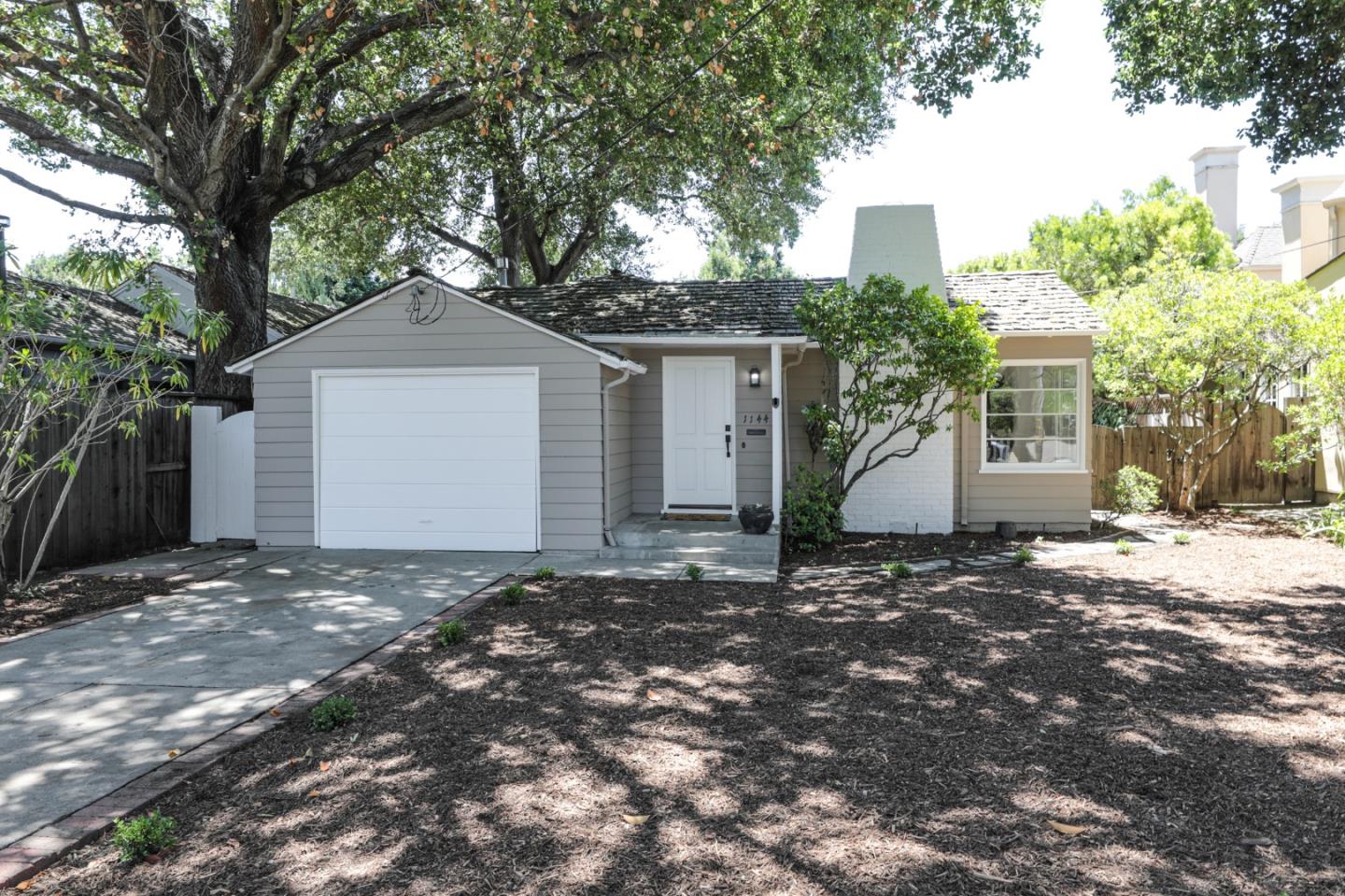 1144 Forest Avenue Palo Alto, CA 94301 - Photo 1 of 22 a front view of a house with a yard and garage