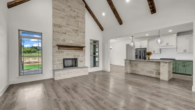 a view of kitchen and front door with wooden floor