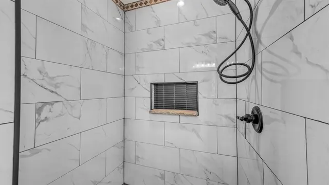 a bathroom with a shower and cabinets