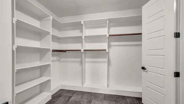 a view of walk in closet with empty racks