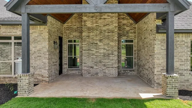 a view of a brick house with a yard