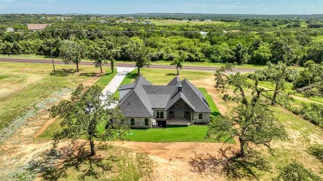 a view of a house with a yard and sitting area