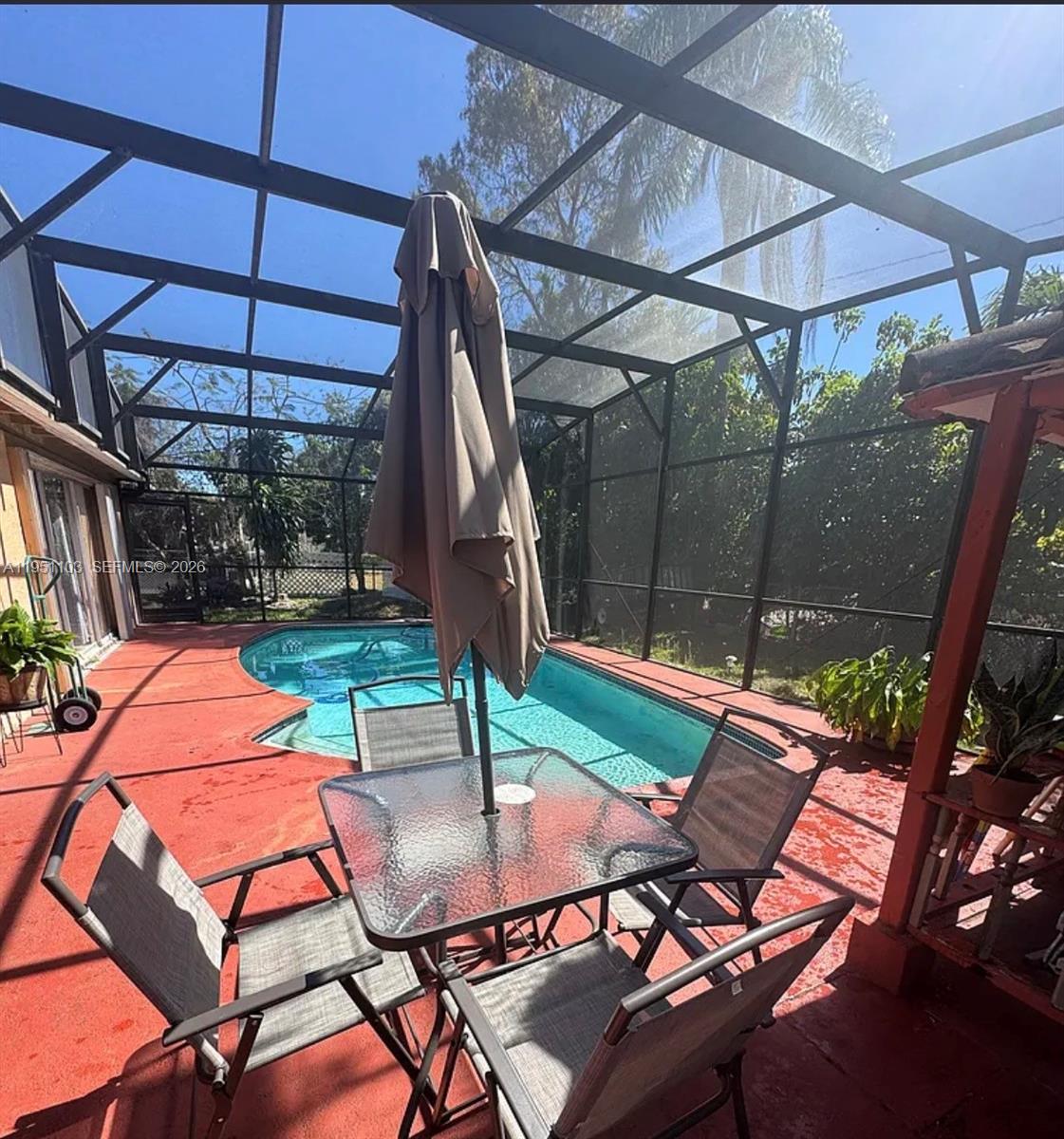 20530 Eagle Nest Road Cutler Bay, FL 33189 - Photo 12 of 17 a patio with a yard table and chairs