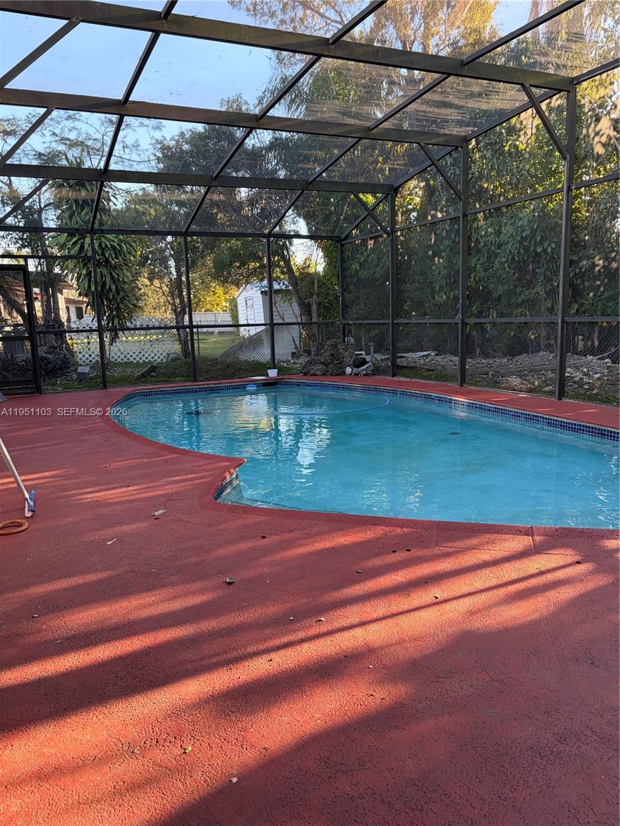 20530 Eagle Nest Road Cutler Bay, FL 33189 - Photo 2 of 17 a view of a tennis ground with trees in the background
