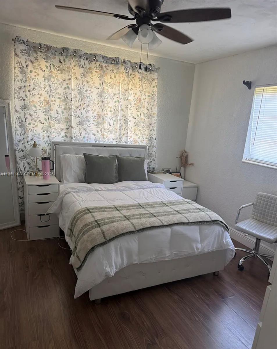 20530 Eagle Nest Road Cutler Bay, FL 33189 - Photo 4 of 17 a bedroom with a bed a chair and a large window