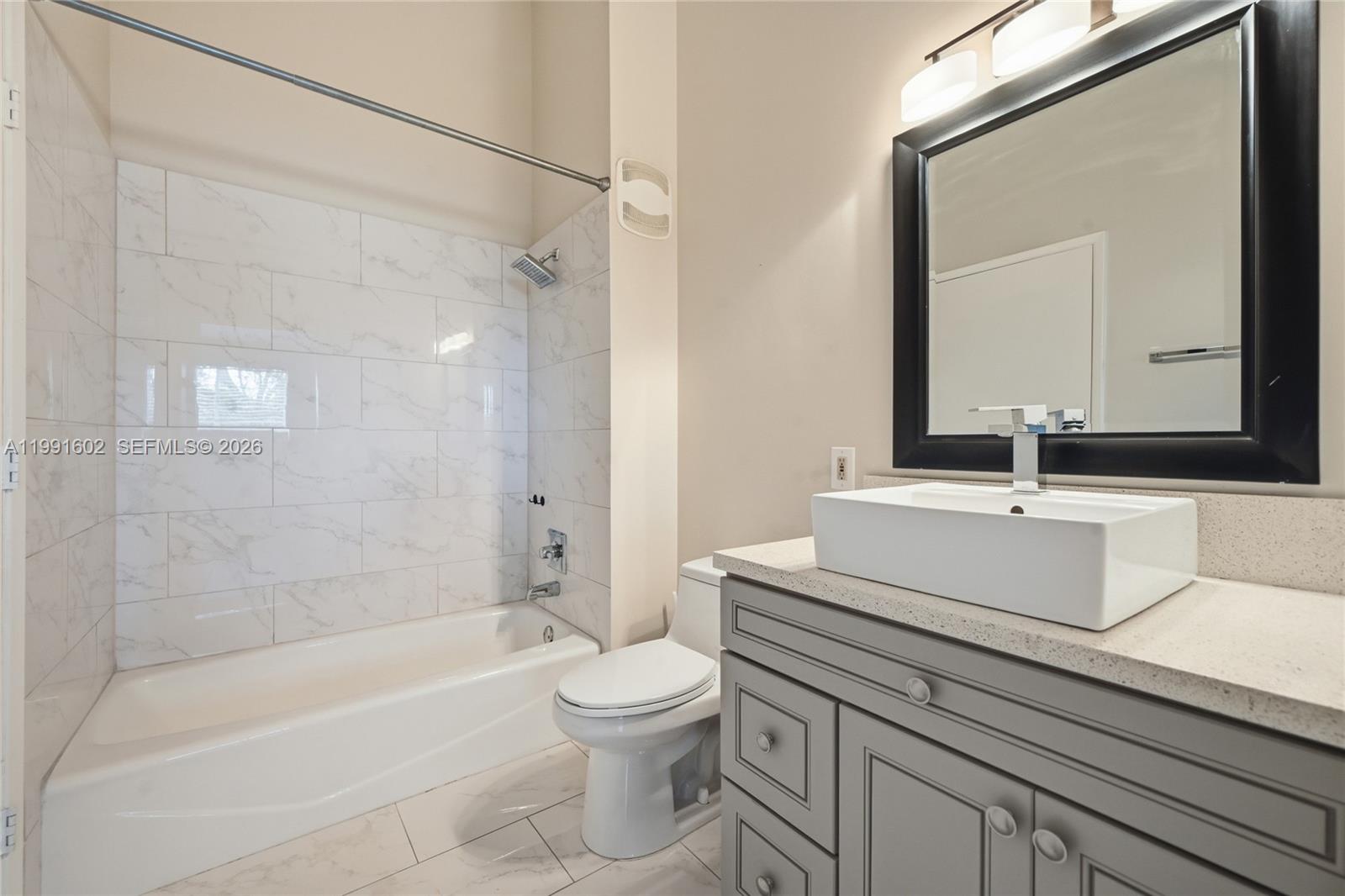 6215 Old Court Road, Unit 505 Boca Raton, FL 33433 - Photo 18 of 36 a bathroom with a sink a toilet and a mirror