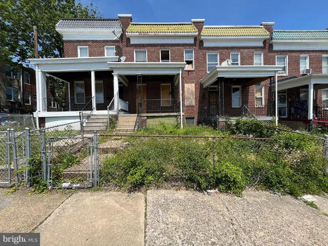 front view of a brick house with a large window